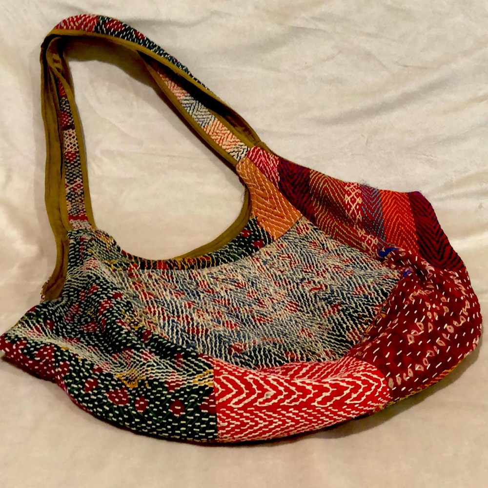 Woven hobo bag with interior side zipper and cell phone pocket.